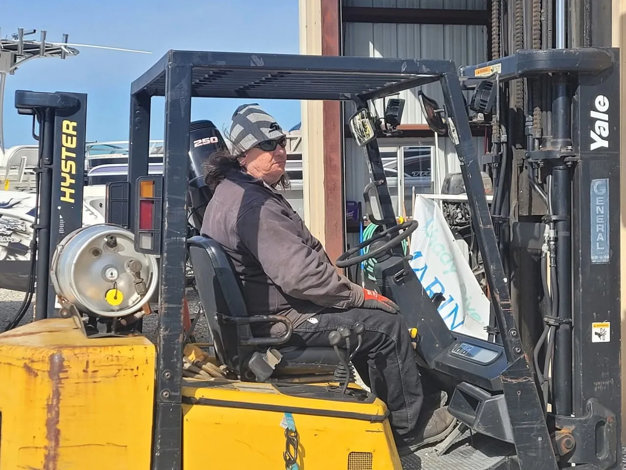 Shady River Marina crew moving a boat with the forklift